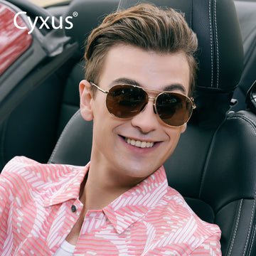 Man wearing 1489 polarized sunglasses sitting in a car with Cyxus logo