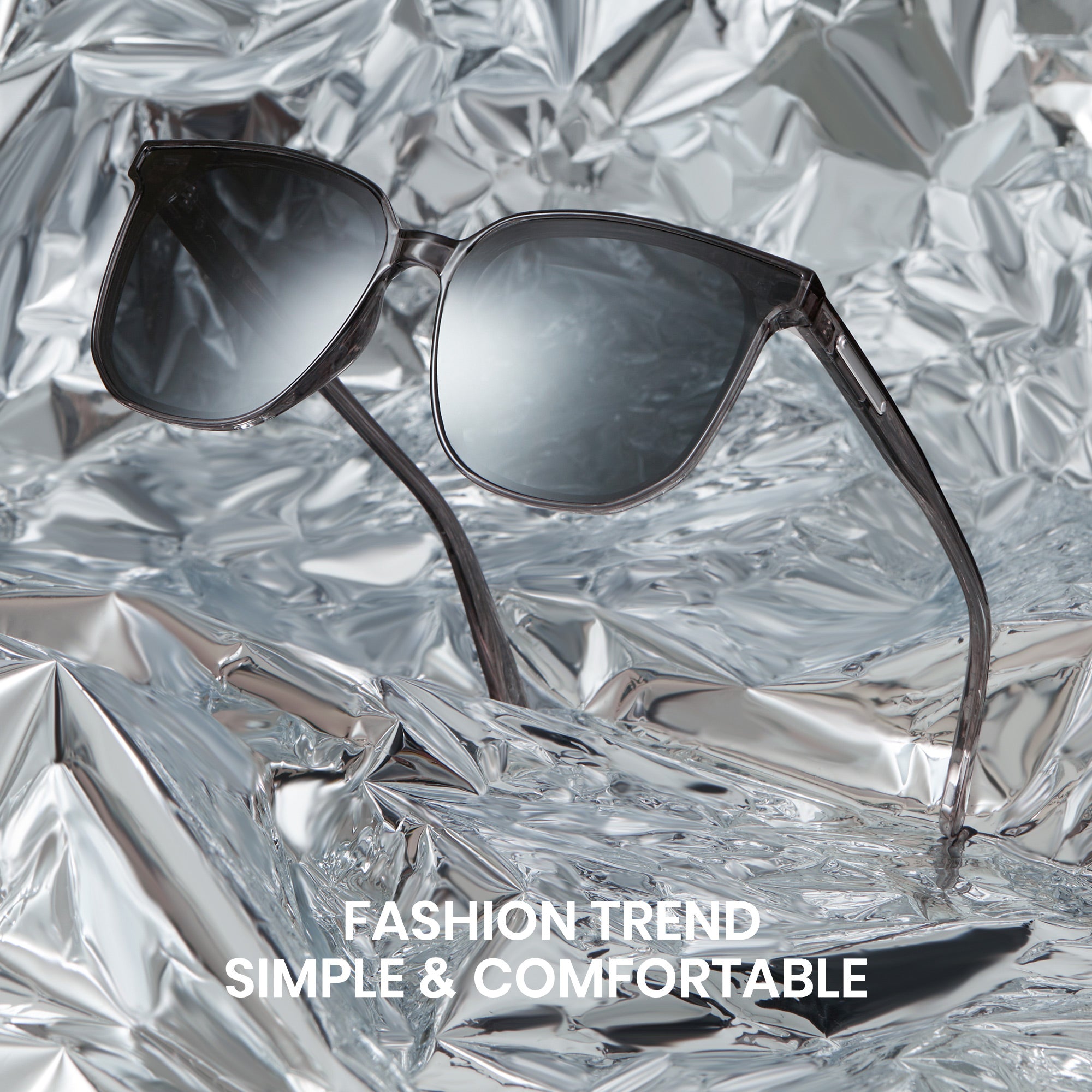 Sunglasses on a textured metallic surface with text 'Fashion Trend Simple & Comfortable'.