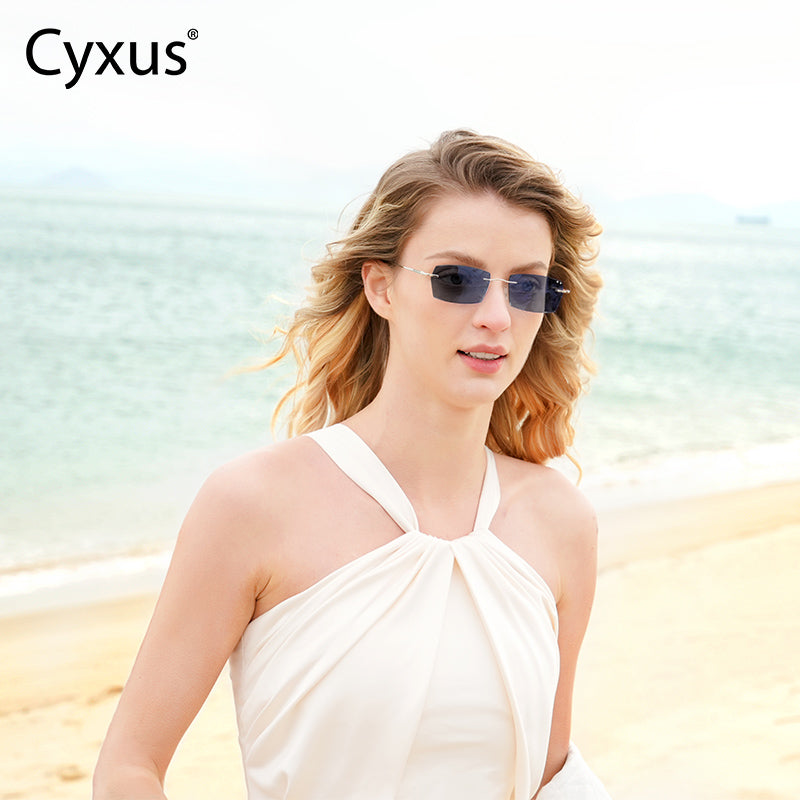 Woman wearing Photochromic Glasses 8127 on a beach with 'Cyxus' branding.