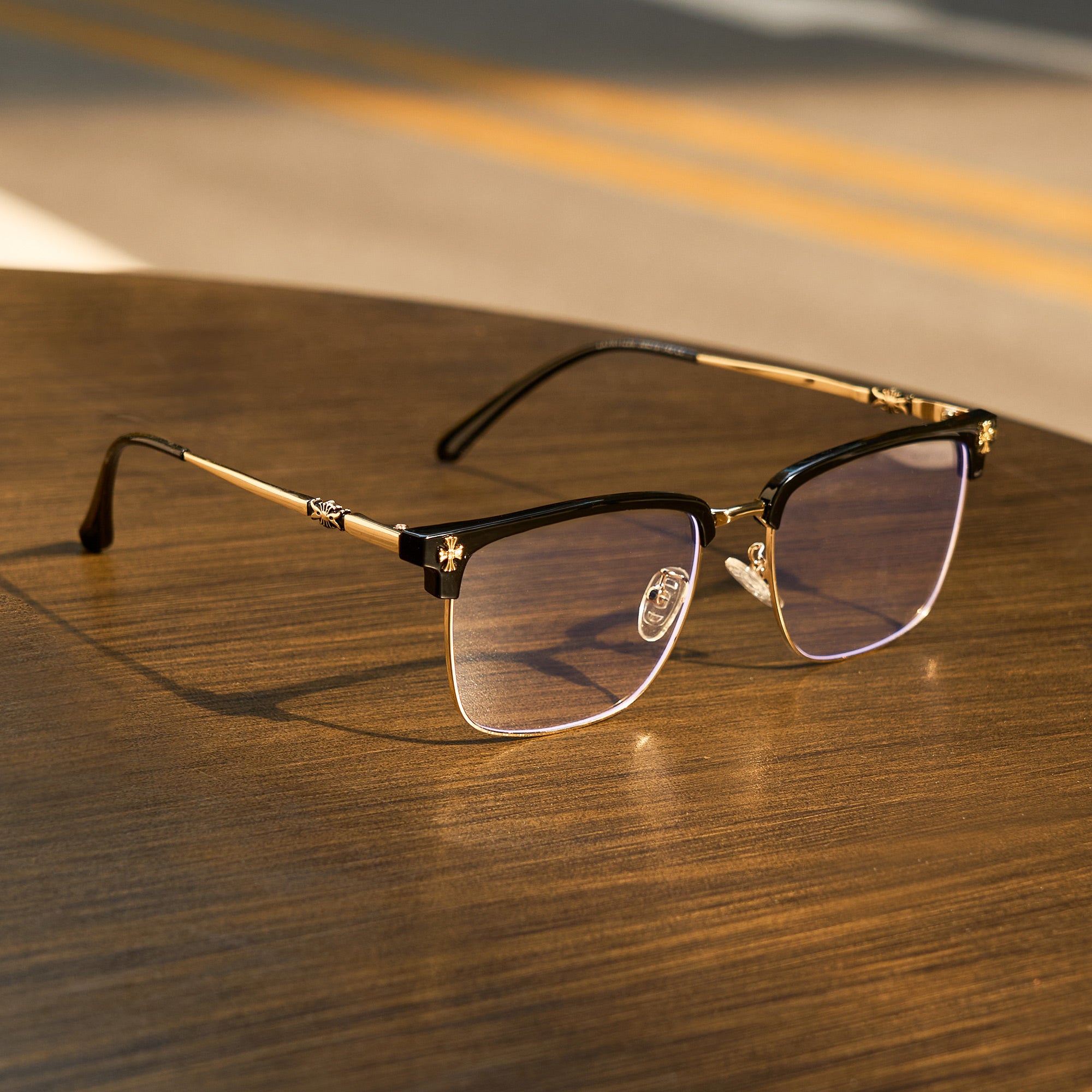Cyxus 8252 eyeglasses with gold frame on a wooden surface