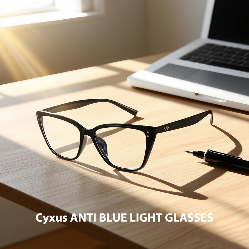Black anti-blue light glasses on a desk with a laptop and pen, featuring 'Cyxus' branding.