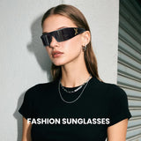 Woman wearing black sunglasses with a plain background