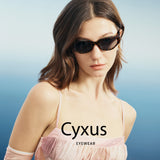 A woman wearing dark cat-eye sunglasses with the brand name 'Cyxus' printed across the chest, set against a soft blue gradient background.