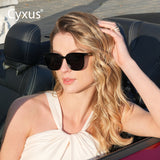 Woman wearing Cyxus polarized sunglasses 1711 sitting in a convertible car with 'Cyxus' branding.