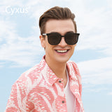 Man wearing sunglasses with a clear blue sky background and 'Cyxus' branding.