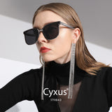 Woman wearing sunglasses with 'Cyxus' branding on a light background