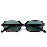 Sunglasses with tortoiseshell frame and dark lenses on a white background