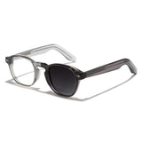 Photochromic glasses with a clear frame and black lenses on a white background
