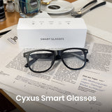 Cyxus Smart Glasses on a newspaper with packaging in the background