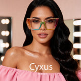 Woman wearing colorful glasses with 'Cyxus' branding in a makeup studio setting