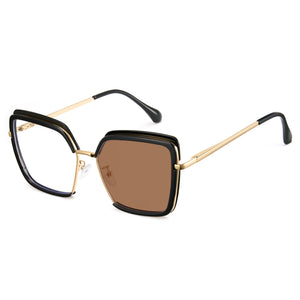 Glossy black oversized photochromic blue light glasses, gold metal temples, white to tea lens