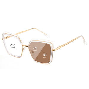 Transparent oversized photochromic glasses, gold metal temples, clear to tea lens