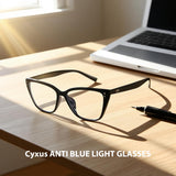 Black anti-blue light glasses on a desk with a laptop and pen, featuring 'Cyxus' branding.