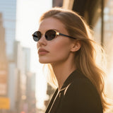 Woman wearing Cyxus sunglasses with a cityscape background